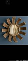 Front view of carved wood sunburst mirror