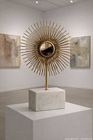 Full view of sunburst sculpture on pedestal