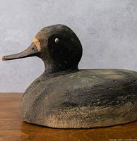 Left profile of hand-carved wooden duck decoy