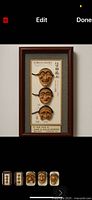 Full view of framed set showing three masks, plaque and frame