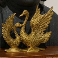 Front view of brass twin swan sculpture
