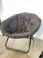 Front view of black papasan-style folding chair