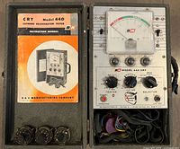 Tester, manual, leads, adapters inside open wood case