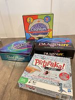 All four boxed board games stacked