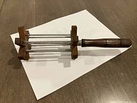 Overall view showing handle, wooden end blocks and four steel rods