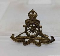 Front view showing crown, cannon, mottos