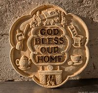 Front view of chalkware wall plaque with raised lettering and cottage motifs