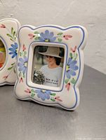 Square floral ceramic frame with blue flowers and pink accents