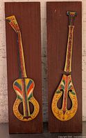 Front view of both ceramic instrument plaques on wood
