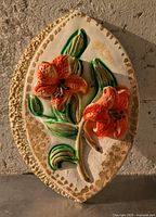 Front view showing relief orange lilies and textured border