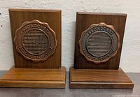 Front view of both maple bookends showing bronze plaques