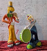 Both papier-mâché clown musician figures side by side