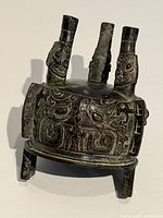 Close-up of cast bronze incense burner showing pattern and patina