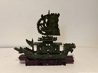 Full view of assembled jade dragon boat on wooden stand