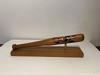 Side view of carved and painted bat on stand