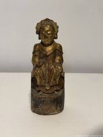 Front view of carved wooden gilt deity figure