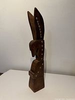 Full view of wooden eagle totem standing upright