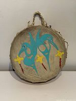 Front of drum with turquoise birds, yellow flowers