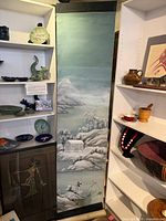 Full view of long vertical acrylic scroll painting between shelving