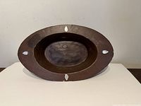 Full view of oval wooden bowl showing abalone inlays