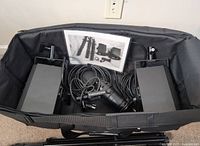 Kit inside Videssence carry case showing two soft floods, spotlight, cables, instruction sheet