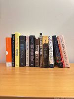 Full row of 13 books standing on shelf