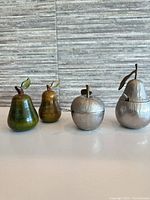 group view of two wooden pears and two metal fruit servers