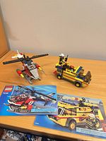 Both assembled Lego sets with instruction manuals displayed on table