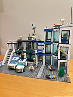 Overall view of assembled LEGO City Police Station set with vehicles and minifigures