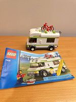 Instruction booklet front cover and assembled camper van with roof bicycle visible