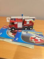 Assembled LEGO fire truck on top of both manuals