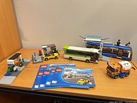 Overview of completed LEGO 8404 set with vehicles, station structures and manuals