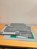 Stack of baseplates showing large gray baseplate and assorted road plates