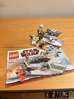 Instruction booklet, turret build, four minifigures visible