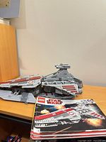 Assembled Republic Attack Cruiser with instruction manual on desk