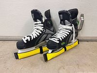Pair of skates side by side with blade guards on