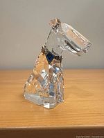Front/side view of Swarovski crystal dog with blue crystal collar