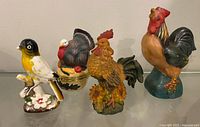 Front view of four ceramic bird figurines.