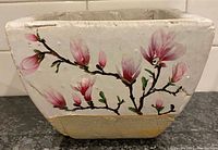 Front view showing magnolia artwork and overall shape