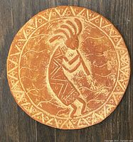 Full view of round plate showing Kokopelli design and border