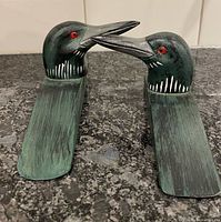 Front view pair of carved loon door stoppers