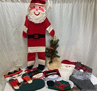 Full lot view showing wooden Santa, stockings, tabletop tree