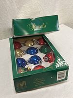 Closed Rauch box showing branding and view window with ornaments inside