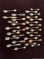 All 29 souvenir spoons laid out for overview