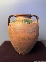Front view of terracotta jar showing overall shape and handles