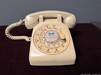 Front view showing full telephone, handset, rotary dial and Bell logo