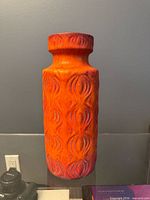 Full view of orange Scheurich vase showing pattern and form