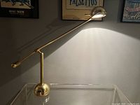 Full view of brass desk lamp illuminated