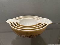 Stacked view of all four nesting Cinderella bowls showing exterior pattern and nesting capability