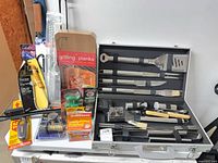 Overall view showing aluminum case of utensils with additional packaged accessories